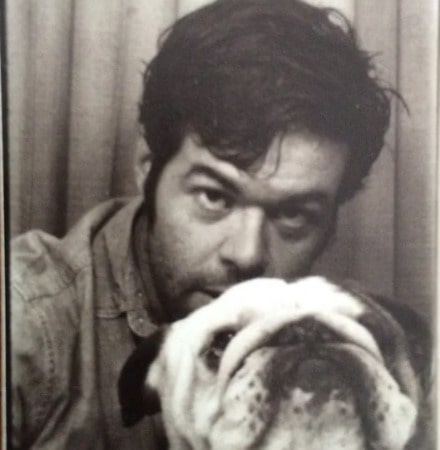 Robert Baker with his puppy in a black and white photo.